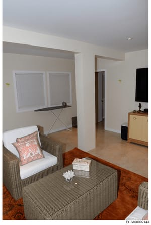 This photograph documents an interior room, likely from one of Epstein's properties, showing a furnished living area with contemporary décor. The image captures the room's layout, furnishings, and design elements as evidence documentation during the 