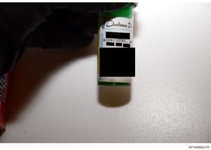 This is a photograph of a bottle with a handwritten label identifying it as belonging to 'Chelsea D.' with the name 'RODRIGUEZ, AM' partially visible beneath redacted sections. The bottle contains a clear or light-colored liquid and appears to be evi
