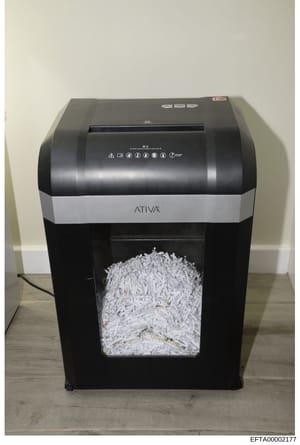 This is a photograph of an ATIVA brand paper shredder containing shredded documents. The shredder appears to be a desktop model with a full collection bin of finely shredded paper. This type of evidence photo is typically used in investigations to do