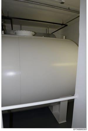 This is an evidence photograph showing the interior of a bathroom or utility room, featuring exposed ceiling infrastructure, recessed lighting fixtures, and white paneled walls. The image appears to be from a property inspection or forensic documenta