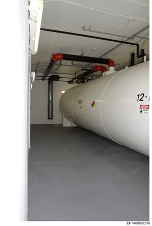 This is an evidence photograph showing the interior of a fuel storage room containing a large horizontal diesel fuel tank (labeled 12') with safety infrastructure including red shut-off valves, piping, and a 'Danger: Diesel Fuel' warning label. The i