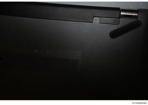 This photograph shows the back panel of an electronic device, likely a laptop or computer component, with minimal identifying markings visible. The image appears to be documentation of physical evidence or seized equipment from the investigation, tho