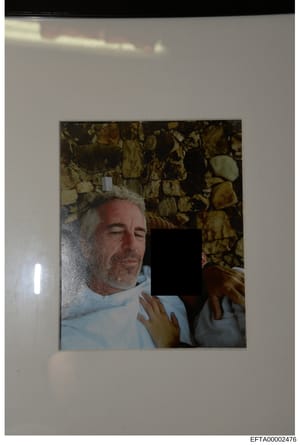This is an evidence photograph showing a middle-aged male with gray/white hair wearing a light blue shirt, positioned against a stone or brick wall background. A portion of another person is visible on the right side of the frame, with their face red