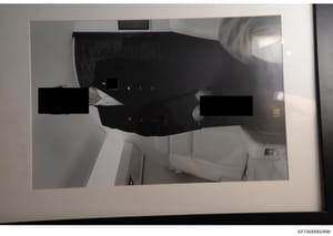 This is an evidence photograph showing the interior of an aircraft cabin, likely from Epstein's private jet. The image shows two individuals whose faces and identities are heavily redacted with black rectangles. The cabin features white leather seati