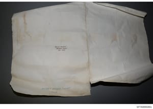 This photograph shows two white fabric items (possibly pillow cases or linens) with handwritten labels indicating they are from evidence surveys conducted in November 2005 and 2002. The items are labeled 'BRIAN MASSEY PROCESS SURVEY Nov 2005' and 'MA