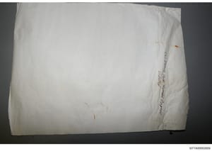 This is a photograph of a white envelope or package with handwritten text on its side. The visible handwriting appears to read 'Anne Russell, imported Packing' or similar text, though the exact wording is difficult to discern due to the angle and ima