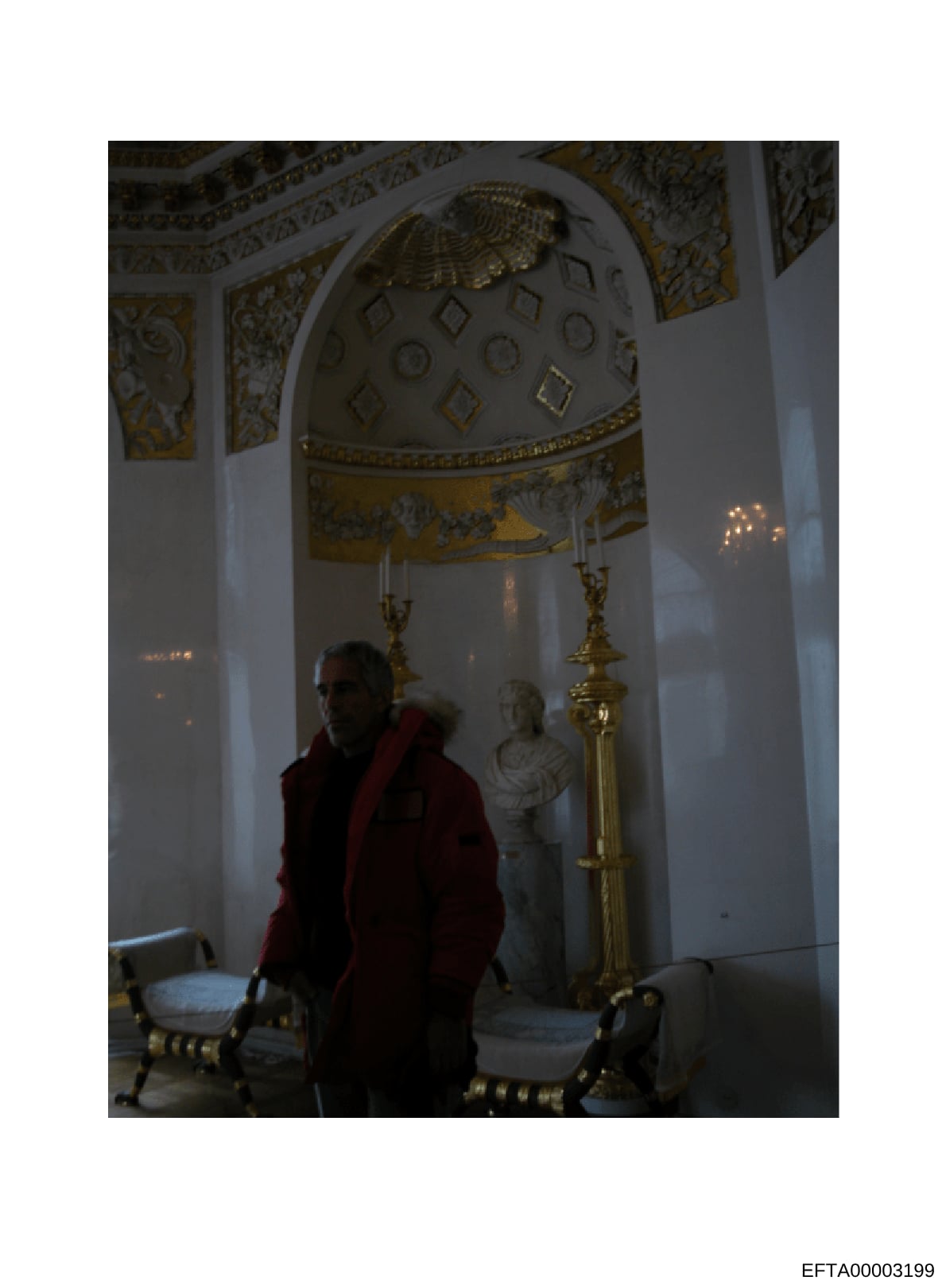 This is a photograph of an elaborately decorated interior space featuring neoclassical architecture, including a domed ceiling with gold leaf ornamentation, white walls with decorative molding, and classical furnishings. A single male figure in a red
