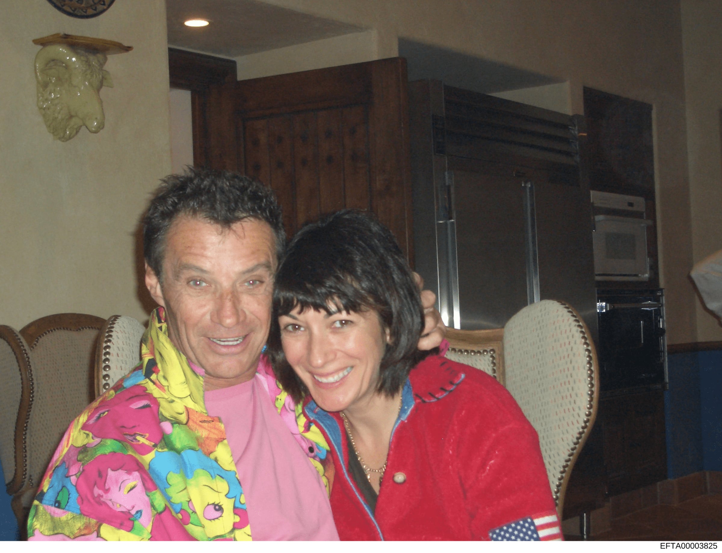 This is a casual photograph taken in what appears to be a high-end residential kitchen, showing two people posing together. The image appears to be from the Epstein investigation files and documents social interactions within his properties. The phot
