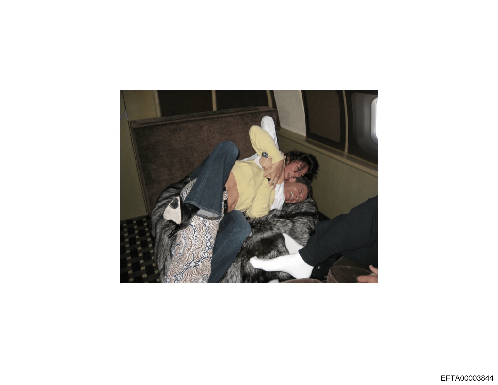This is a photograph showing a person in a yellow shirt and white cap seated in what appears to be the interior of a vehicle. The image captures an interior scene with upholstered seating and windows visible in the background. The photograph is part 