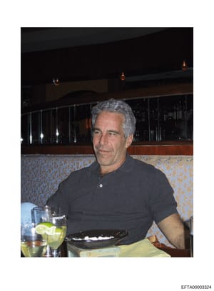 This is an evidence photograph showing Jeffrey Epstein seated at what appears to be an upscale restaurant or private venue. The image captures him in a casual black polo shirt, seated at a booth with patterned upholstery, with a beverage in front of 