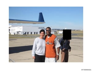 A photograph taken on an airport tarmac showing three people posing in front of a large aircraft with its tail visible in the background. The image appears to be from a casual outing or social gathering at what looks like a commercial or private avia