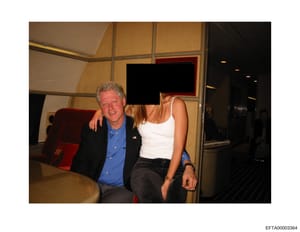 This is a photograph showing two people sitting together in what appears to be an upscale interior space with modern furnishings. One individual's face has been redacted with a black box. The photo is part of the Epstein investigation evidence files 