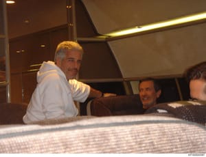This is a photograph taken inside a private aircraft cabin showing at least three men in the interior. The image appears to be evidence documentation from the investigation, capturing individuals aboard what appears to be a luxury jet with upholstere
