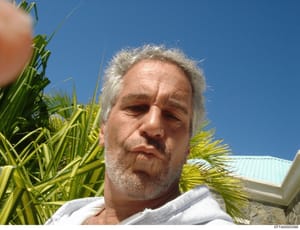 This is a casual personal photograph showing Jeffrey Epstein outdoors in a tropical location, surrounded by palm fronds with a clear blue sky visible. The image appears to be a selfie taken in bright daylight. This type of personal photo may be relev