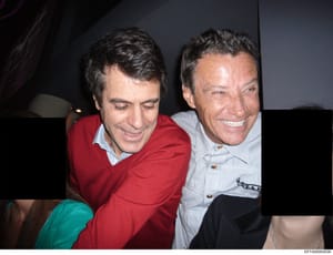 This is a photograph showing two men at what appears to be an indoor social gathering or event. The image is part of the Epstein investigation files but does not contain identifying captions or context within the document itself. Without additional m