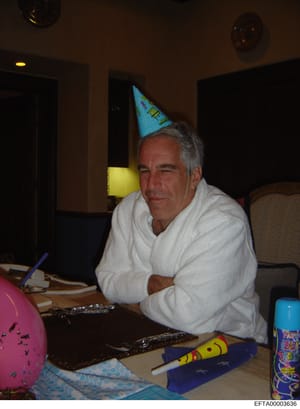 This is an evidence photograph showing a man wearing a blue party hat seated at a table during what appears to be a birthday celebration. The image captures party decorations including balloons, party favors, and other celebratory items on the table.