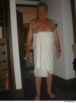 This is a personal photograph showing a middle-aged male in an indoor residential setting. The image appears to be casual documentation, possibly from a residence or hotel. The photo is marked with a timestamp watermark and carries an EFTA evidence i