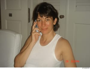 This is a personal photograph showing a woman in a residential bathroom, speaking on a mobile phone. The image appears to be from the early 2000s based on the phone style and photo quality. The timestamp visible in the image reads '24 0:35pm'. The do
