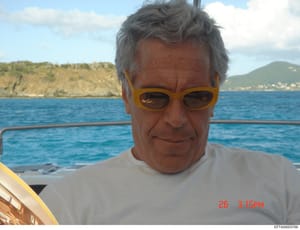 This is a personal photograph showing a man wearing yellow-framed sunglasses and a white t-shirt on a boat. The image appears to be taken during leisure time, with a coastal landscape visible in the background. The photo is dated March 26 (timestamp 