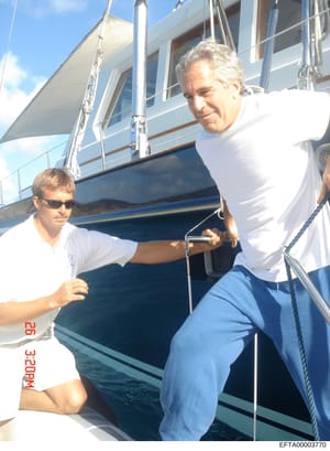 This is a casual photograph taken aboard a large motor yacht, showing two men in white and blue casual clothing. The image appears to be from the mid-2000s based on the photo quality and dating stamp. The yacht is substantial with multiple decks, rai