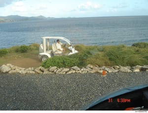 This is a photograph taken at a beach or coastal area showing a white golf cart with at least one occupant. The image appears to be candid surveillance or investigative photography, dated with a timestamp of 31 4:38PM visible in the corner. The locat