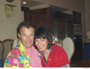 This is a casual photograph taken in what appears to be a high-end residential kitchen, showing two people posing together. The image appears to be from the Epstein investigation files and documents social interactions within his properties. The phot