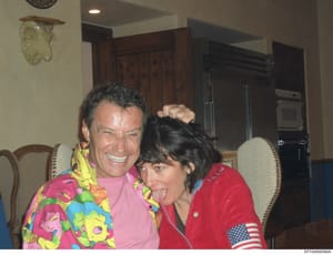 This is a casual photograph taken indoors showing two people in what appears to be a kitchen or dining area. The image appears to be personal documentation from an investigation file and may be relevant to establishing connections or activities durin
