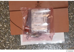 This is an evidence photograph showing a Seagate desktop hard drive (1000GB capacity) sealed in a clear plastic evidence bag labeled 'clone #9'. The hard drive appears to be from a New York CART Lab acquisition and is placed in a brown cardboard evid