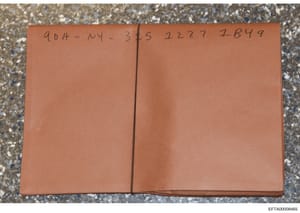 This is a photograph of a sealed tan or rust-colored folder or envelope with handwritten markings on the cover. The visible notation reads '904-NY-3/5 2227 7B49,' which appears to be a case reference, location code, and identification number. The fol
